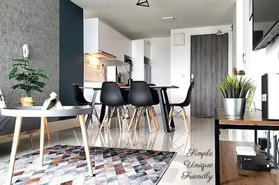 a living room with a table and black chairs at Modern Suites 3Beds at Continew, TRX KLCC view, Next to IKEA in Kuala Lumpur