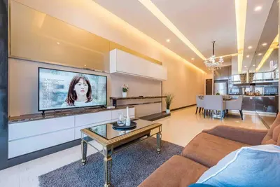 a living room with a flat screen tv on a wall at Dorsett Residence Kuala Lumpur 15 in Kuala Lumpur