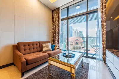 a living room with a couch and a glass table at Dorsett Residence Kuala Lumpur 15 in Kuala Lumpur