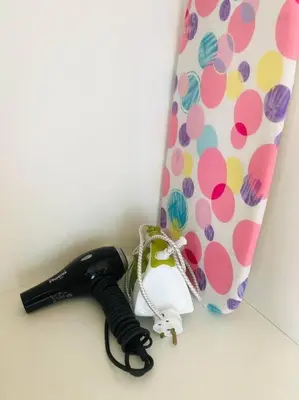 a black umbrella next to a bag with polka dots at Dorsett Residence Kuala Lumpur 15 in Kuala Lumpur