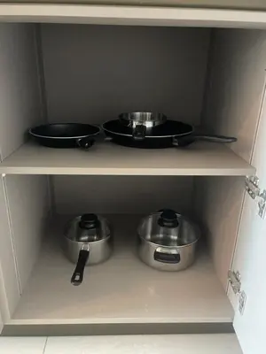 three pots and pans on a shelf in a kitchen at Opus Residences Warisan Merdeka by C&C Fortune in Kuala Lumpur