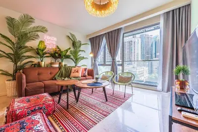 a living room with a couch and a table and chairs at 2min walk to Lot 10, 5 min to Pavillion 2BR 8-2 WIFI 100mbps in Kuala Lumpur