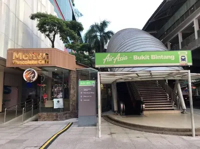 a building with a bus stop and a building with a building with a staircase at 2min walk to Lot 10, 5 min to Pavillion 2BR 8-2 WIFI 100mbps in Kuala Lumpur