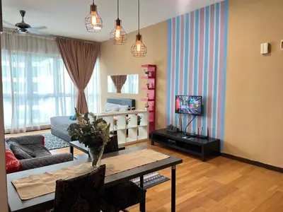 a living room with a table and a couch at Luxury Regalia suites by adnan in Kuala Lumpur