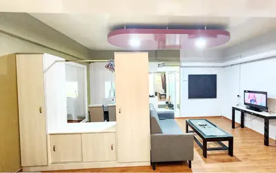 a living room with a couch and a table at Holiday Hostel KLCC in Kuala Lumpur