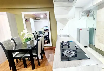 a kitchen and dining room with a table and a stove at Holiday Hostel KLCC in Kuala Lumpur
