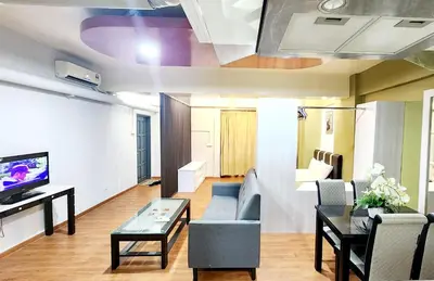 a living room with a couch and a table at Holiday Hostel KLCC in Kuala Lumpur