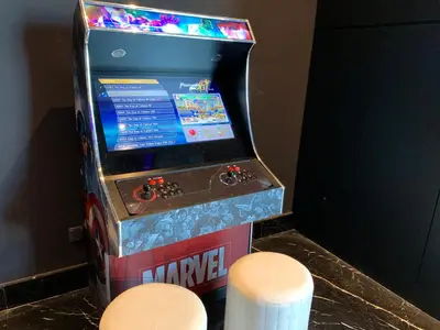 a video game machine with two stools in front of it at Star Suite 5min Walk to KLCC Netflix in Kuala Lumpur