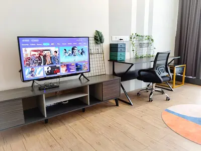 a living room with a television on a desk at The Parkville - Bangsar Trade Centre in Kuala Lumpur