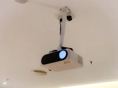 a tv hanging from the ceiling of a room at The Luxmi - Bangsar Trade Centre in Kuala Lumpur