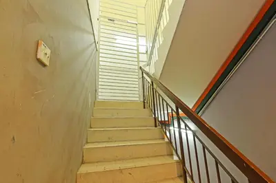 a stairway in a building with a stair case at Hotel O Sri Rampai Metro Hostel in Kuala Lumpur