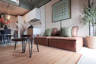 a living room with a couch and a table at Modern Designer Suite at Continew, TRX KLCC View, Next to IKEA in Kuala Lumpur