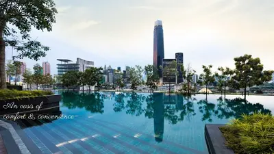 a swimming pool with a city in the background at Modern Designer Suite at Continew, TRX KLCC View, Next to IKEA in Kuala Lumpur