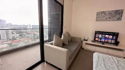 a living room with a couch and a large window at KL Sentral Loft, EST Bangsar #6, LRT in Kuala Lumpur