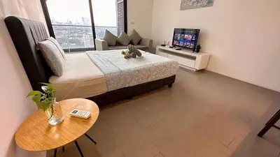 a small room with a bed and a television at KL Sentral Loft, EST Bangsar #6, LRT in Kuala Lumpur