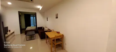 a living room with a table and a couch at Taragon BBCC in Kuala Lumpur