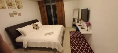 a small bedroom with a bed and a television at Taragon BBCC in Kuala Lumpur