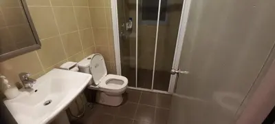 a bathroom with a toilet and a sink and a shower at Taragon BBCC in Kuala Lumpur