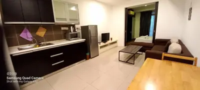 a kitchen and living room with a couch and a refrigerator at Taragon BBCC in Kuala Lumpur