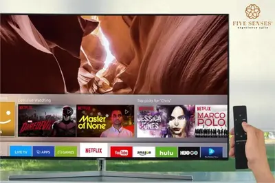 a person holding a wii remote in front of a tv at The Colony & The Luxe, Kuala Lumpur by Canopy Lives in Kuala Lumpur