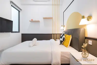 a hotel room with a large bed and a tv at The Colony & The Luxe, Kuala Lumpur by Canopy Lives in Kuala Lumpur
