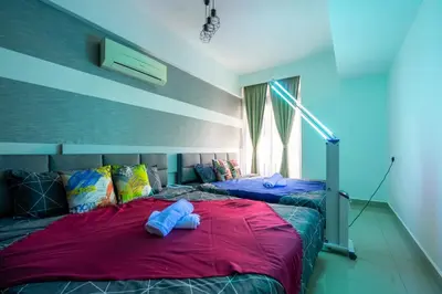 two beds in a bedroom with blue towels on them at Fahenheit 88, Kuala Lumpur 17 in Kuala Lumpur