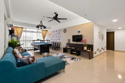 a living room with a blue couch and a pool table at Fahenheit 88, Kuala Lumpur 17 in Kuala Lumpur