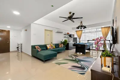 a living room with a green couch and a table at Fahenheit 88, Kuala Lumpur 17 in Kuala Lumpur