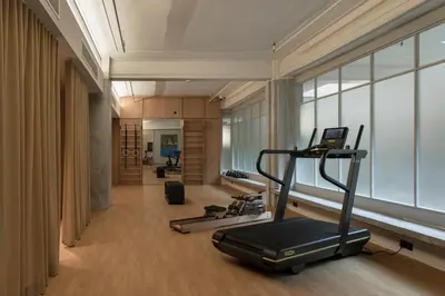 a gym with two treadmills and a treadmill in a room at Else Kuala Lumpur, a member of Design Hotels in Kuala Lumpur
