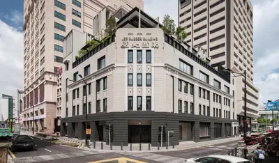 a large white building on a city street with buildings at Else Kuala Lumpur, a member of Design Hotels in Kuala Lumpur