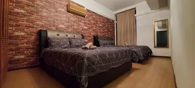 a bedroom with a bed and a brick wall at Fahrenheit 88, Kuala Lumpur 11 in Kuala Lumpur