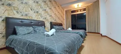 a bedroom with two beds with money on the wall at Fahrenheit 88, Kuala Lumpur 11 in Kuala Lumpur