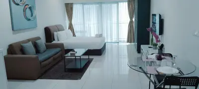 a living room with a couch and a bed at Mercu Summer Suites KLCC by Star Residence in Kuala Lumpur