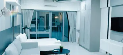 a living room with a white couch and a table at Mercu Summer Suites KLCC by Star Residence in Kuala Lumpur