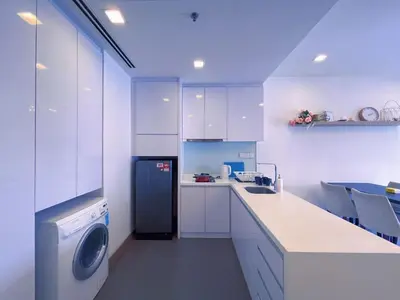 a white kitchen with a dishwasher and a washer at 6PAX SUITES KL CITY Pavilion at Bukit Bintang NETFLIX & WIFI in Kuala Lumpur
