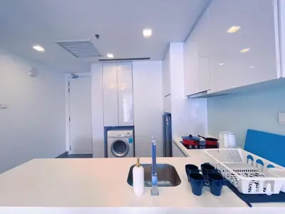 a kitchen with a sink and a washing machine at 6PAX SUITES KL CITY Pavilion at Bukit Bintang NETFLIX & WIFI in Kuala Lumpur