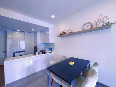a dining room with a table and a clock on the wall at 6PAX SUITES KL CITY Pavilion at Bukit Bintang NETFLIX & WIFI in Kuala Lumpur