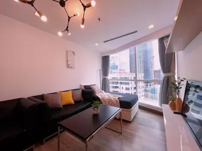 a living room with a couch and a large window at 6PAX SUITES KL CITY Pavilion at Bukit Bintang NETFLIX & WIFI in Kuala Lumpur