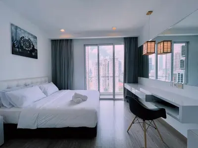 a bedroom with a white bed and a desk and window at 6PAX SUITES KL CITY Pavilion at Bukit Bintang NETFLIX & WIFI in Kuala Lumpur