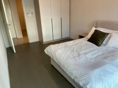 a bedroom with a large bed and a cabinet at The Ooak Suites and Residence@ Kiara 163 in Kuala Lumpur