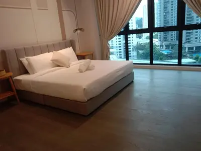 a bedroom with a white bed with a large window at The Ooak Suites and Residence@ Kiara 163 in Kuala Lumpur