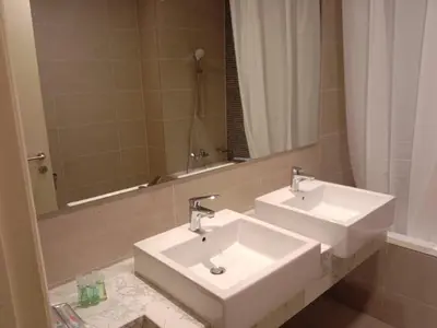 a bathroom with two sinks and a large mirror at The Ooak Suites and Residence@ Kiara 163 in Kuala Lumpur