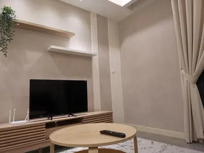 a living room with a flat screen tv and a table at The Ooak Suites and Residence@ Kiara 163 in Kuala Lumpur