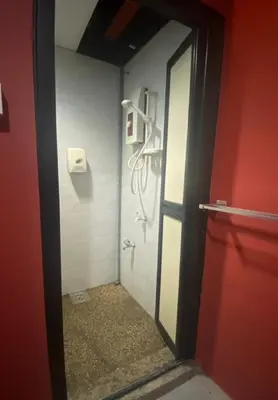a bathroom with a shower with a mirror and a red door at RHV Bukit Bintang , Kuala Lumpur in Kuala Lumpur