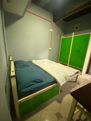 a bed in a room with green and white at RHV Bukit Bintang , Kuala Lumpur in Kuala Lumpur