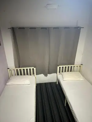 two beds sitting in a small room withermottermottermott at RHV Bukit Bintang , Kuala Lumpur in Kuala Lumpur