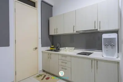 a kitchen with white cabinets and a sink at Lovely 4-bedroom condo with pool for 6 pax - Cheras in Kuala Lumpur