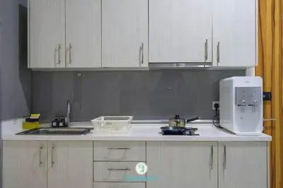 a kitchen with white cabinets and a mixer on a counter at Lovely 4-bedroom condo with pool for 6 pax - Cheras in Kuala Lumpur