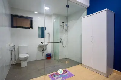 a bathroom with a shower and a toilet at Lovely 4-bedroom condo with pool for 6 pax - Cheras in Kuala Lumpur
