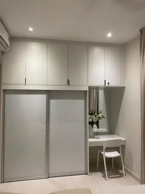 a room with a desk and white cabinets at Lovely Continew Residence 2 Bedrooms - KL in Kuala Lumpur